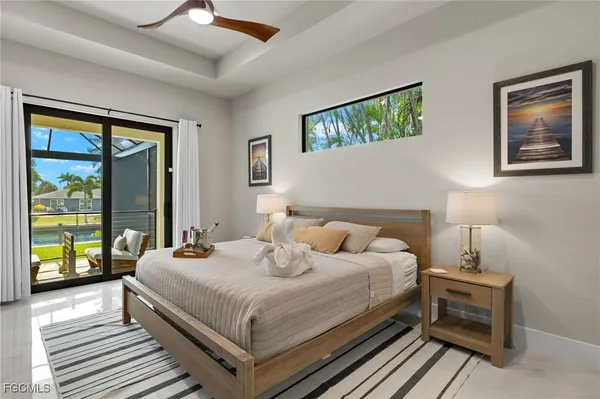 a bedroom with a bed and a large window