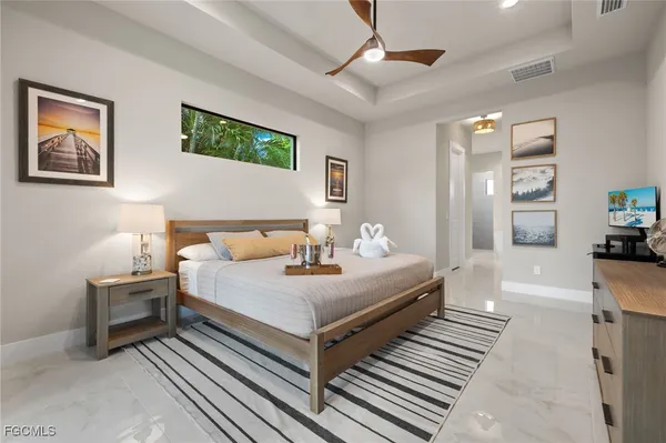 a bedroom with a bed and a chandelier