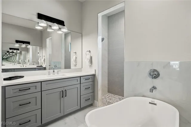 a bathroom with a tub sink and mirror