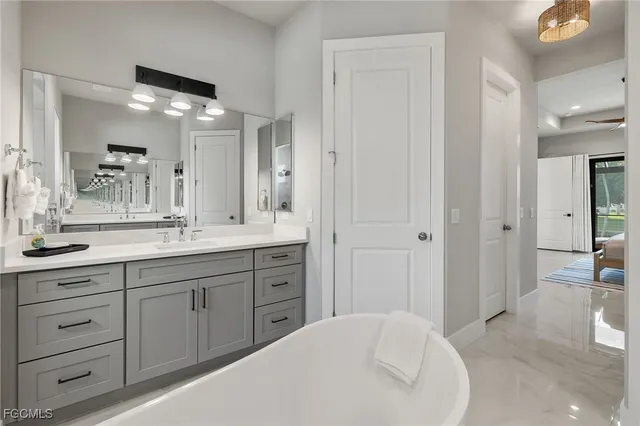a spacious bathroom with a granite countertop sink a mirror and a vanity