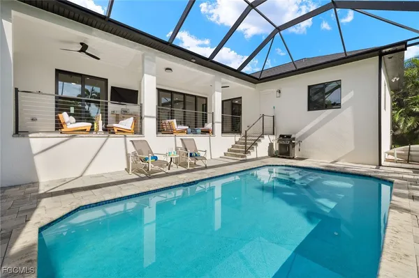 a view of a backyard with swimming pool