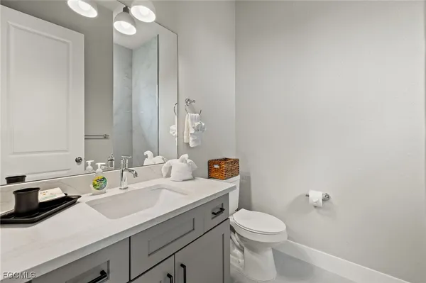 a bathroom with a sink a toilet and mirror