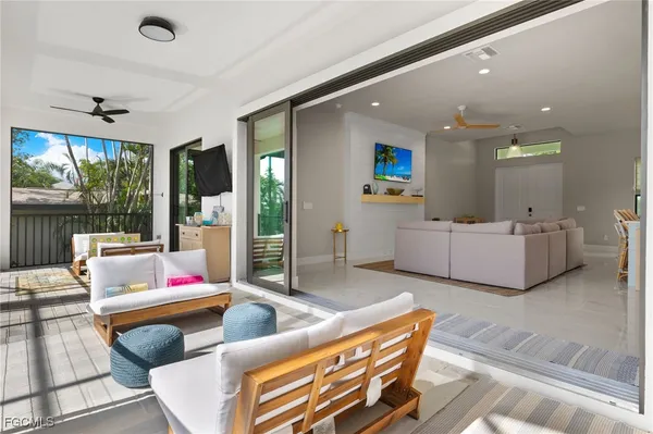 a living room with furniture and a floor to ceiling window