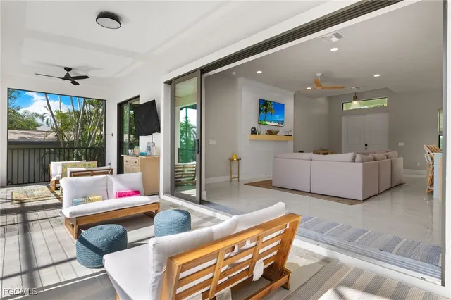 a living room with furniture and a floor to ceiling window