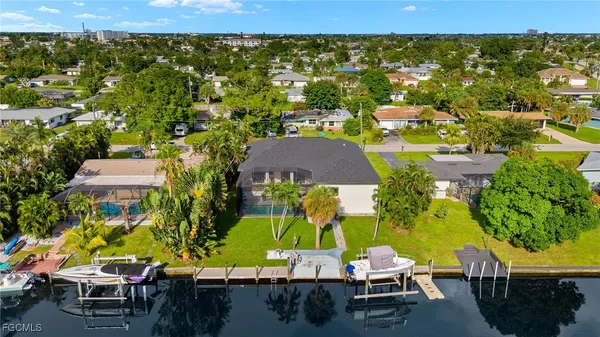 an aerial view of residential houses with outdoor space and parking