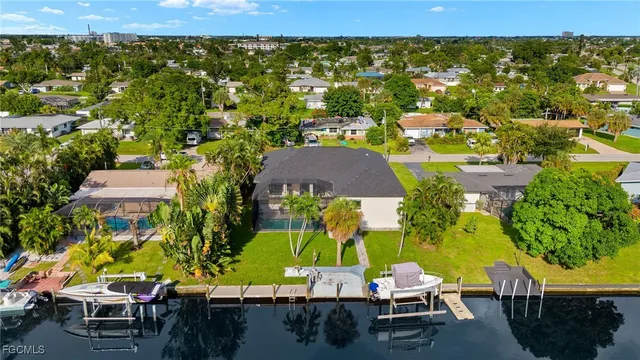 an aerial view of residential houses with outdoor space and parking