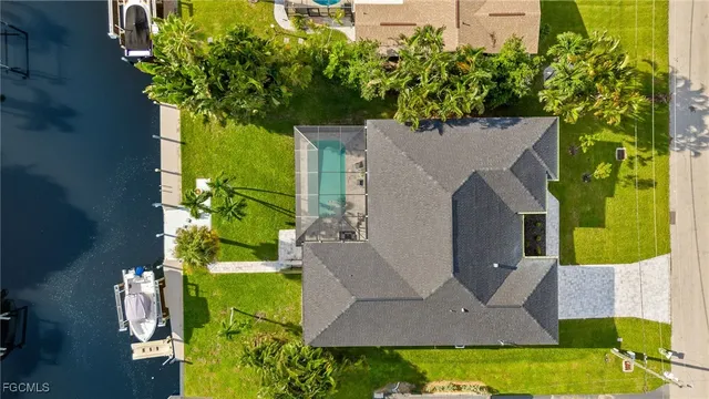 an aerial view of a house with a garden and swimming pool