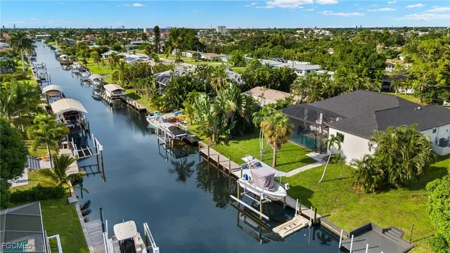 an aerial view of a house with a yard swimming pool outdoor seating