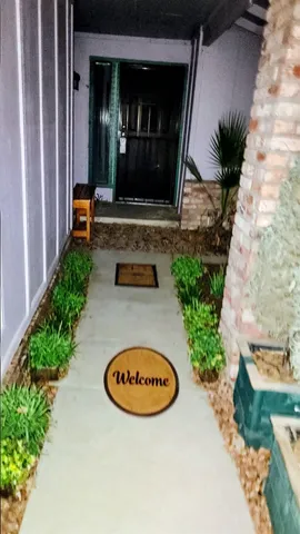 a view of a house with backyard sitting area and garden