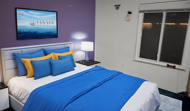 a bed sitting in a bedroom next to a window