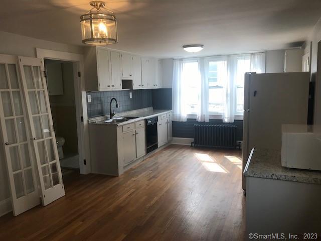 19 Greenfield Avenue Ridgefield, CT 06877 - Photo 5 of 28 a kitchen with stainless steel appliances a refrigerator a sink dishwasher a stove top oven a refrigerator and cabinets