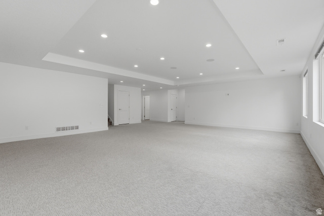 653 East Vandalay Lane Draper, UT 84020 - Photo 33 of 61 Spacious room featuring light gray patterned carpeting, recessed lighting, multiple windows, white walls, and a dropped ceiling element