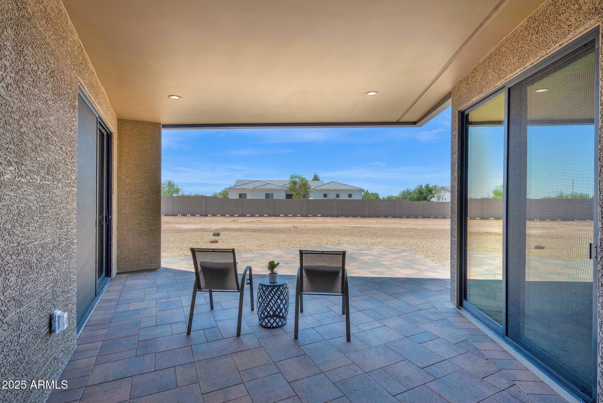 553 West Cavalry Road New River, AZ 85087 - Photo 23 of 26 a view of a patio with a table chairs and backyard