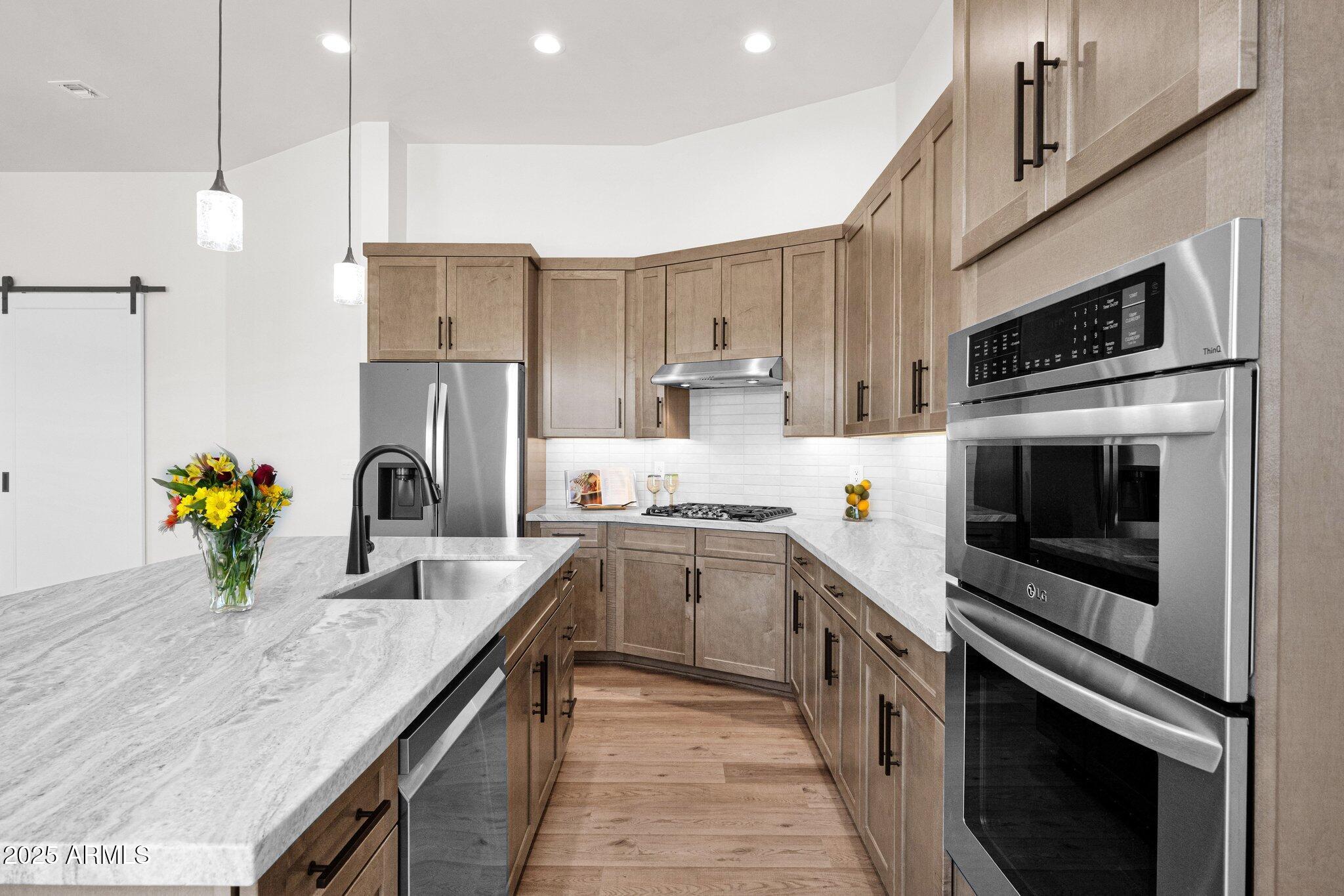 553 West Cavalry Road New River, AZ 85087 - Photo 7 of 26 a kitchen with a sink a stove and oven