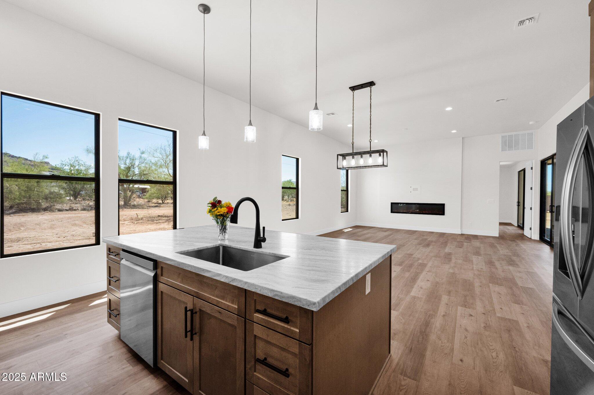 553 West Cavalry Road New River, AZ 85087 - Photo 26 of 26 a kitchen with stainless steel appliances granite countertop a sink a refrigerator and a granite counter tops