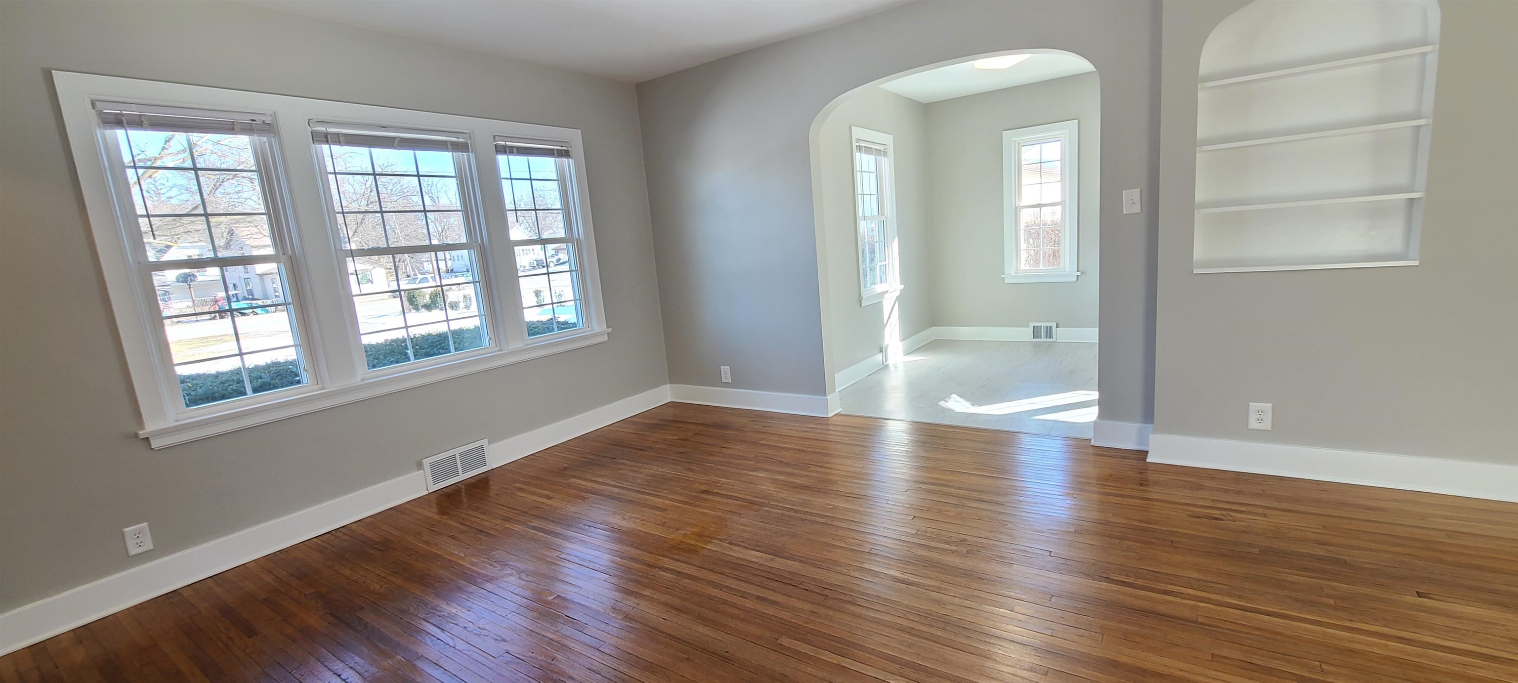 220 South Main Street Rochelle, IL 61068 - Photo 3 of 25 a view of an empty room with wooden floor and a window