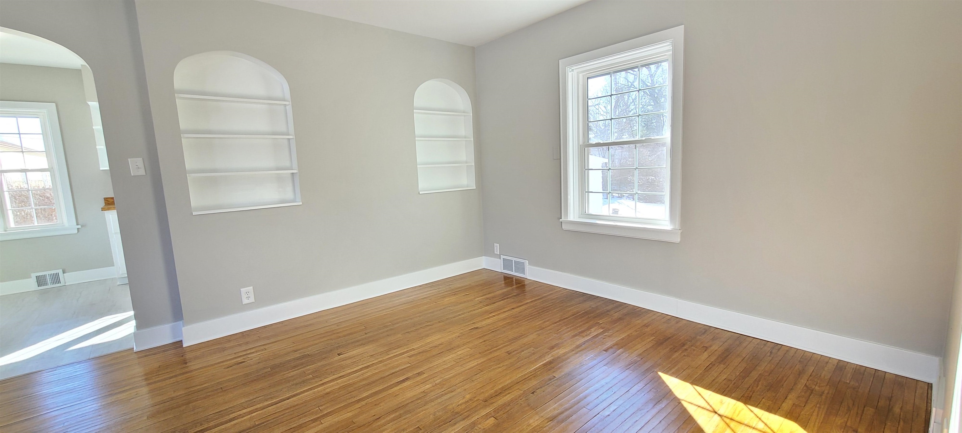 220 South Main Street Rochelle, IL 61068 - Photo 4 of 25 an empty room with wooden floor and windows