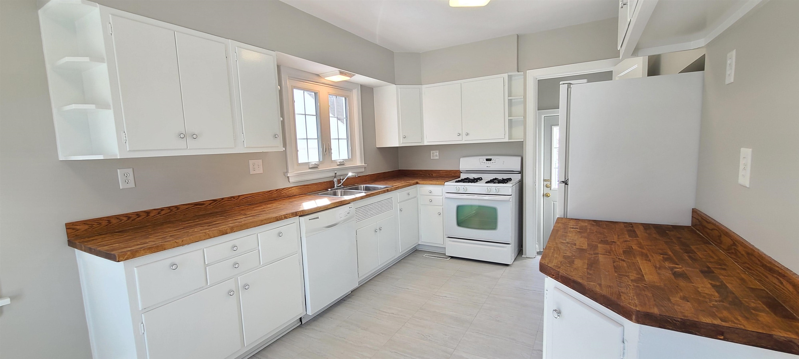 220 South Main Street Rochelle, IL 61068 - Photo 5 of 25 a kitchen with white cabinets and white appliances