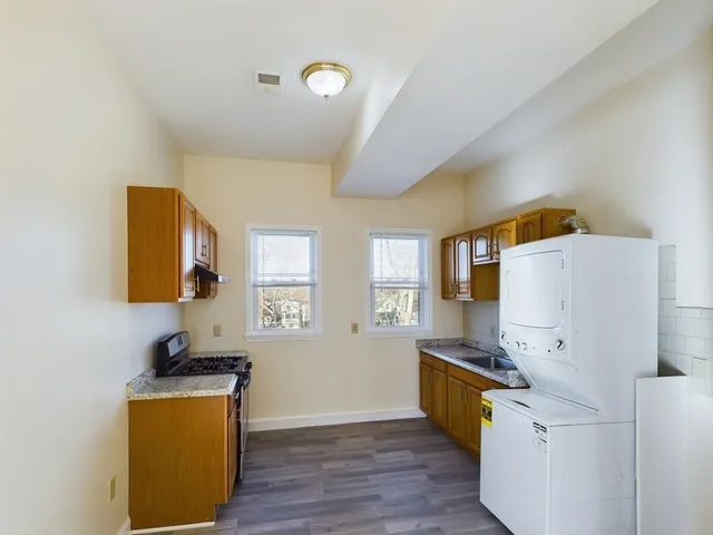 a bathroom with a double vanity sink toilet and mirror