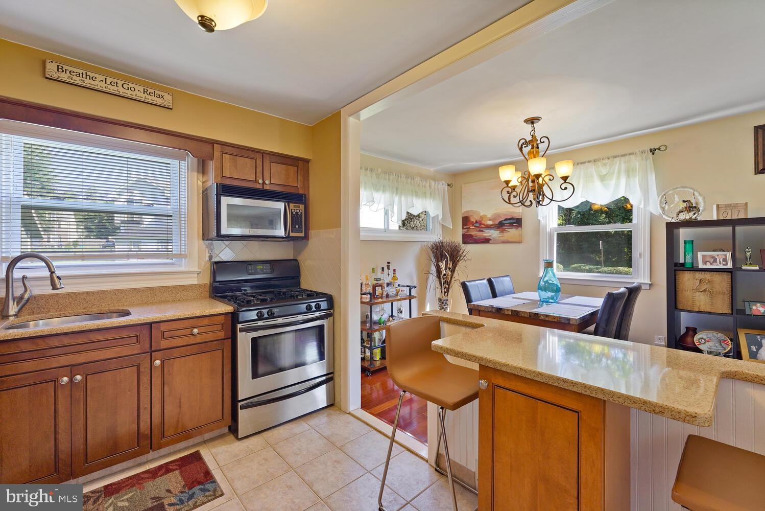 1101 Wynnbrook Road Secane, PA 19018 - Photo 7 of 19 a kitchen with stainless steel appliances granite countertop a sink stove and refrigerator