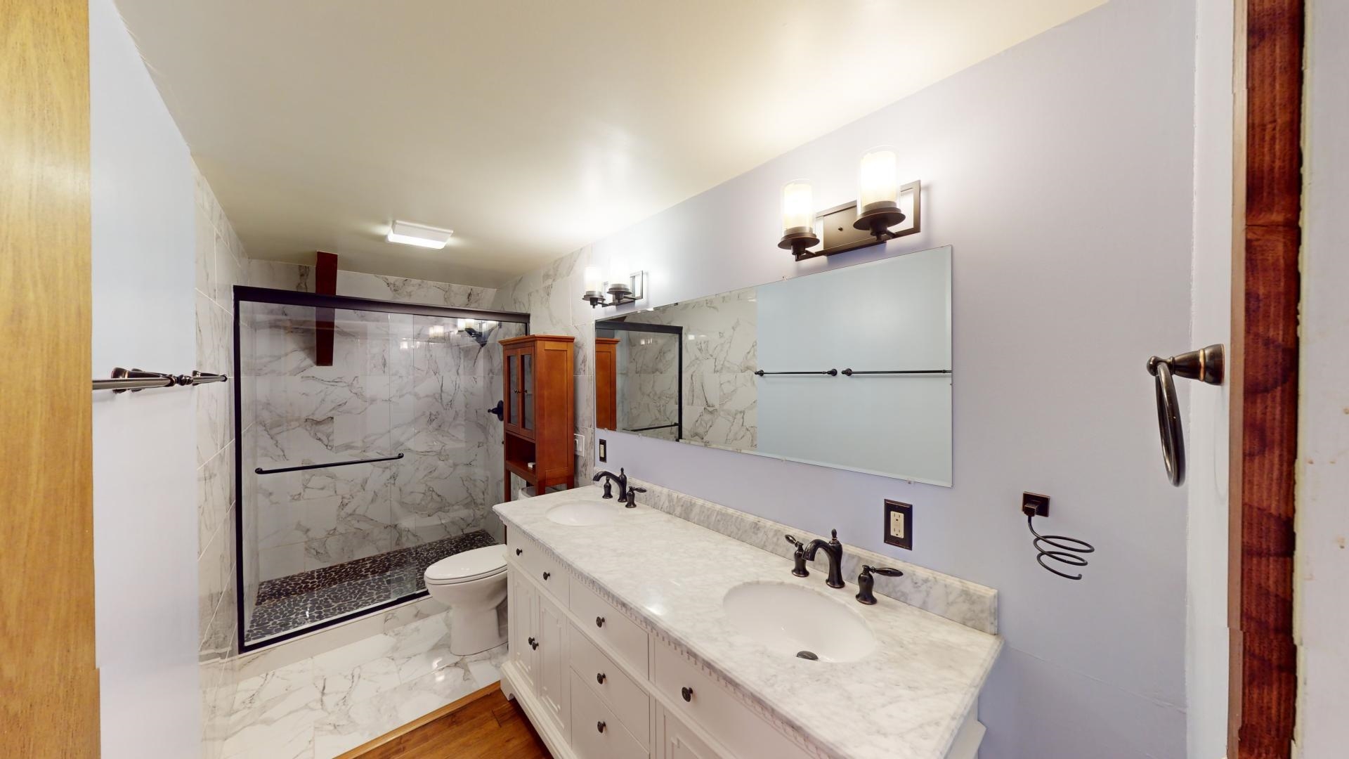 32 John Muir Road Mammoth Lakes, CA 93546 - Photo 19 of 42 a bathroom with a sink mirror toilet and shower
