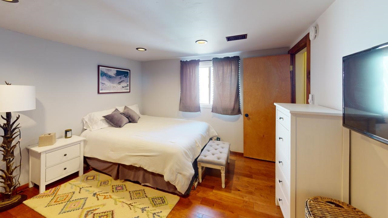 32 John Muir Road Mammoth Lakes, CA 93546 - Photo 20 of 42 a bedroom with a bed and a tv on the dresser