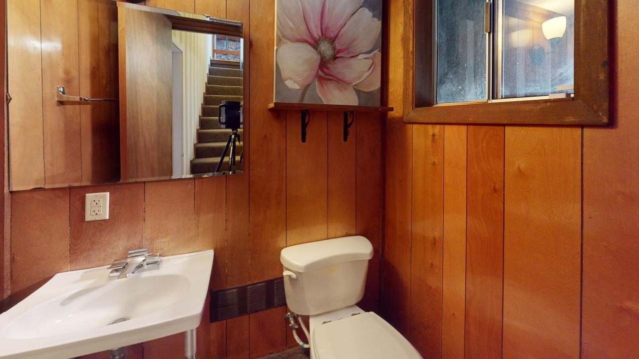 32 John Muir Road Mammoth Lakes, CA 93546 - Photo 23 of 42 a bathroom with a toilet sink and mirror