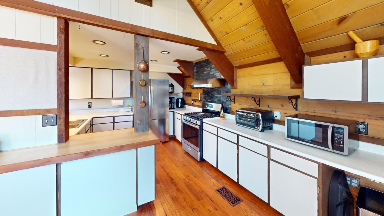 32 John Muir Road Mammoth Lakes, CA 93546 - Photo 6 of 42 a kitchen with stainless steel appliances granite countertop a sink and a stove