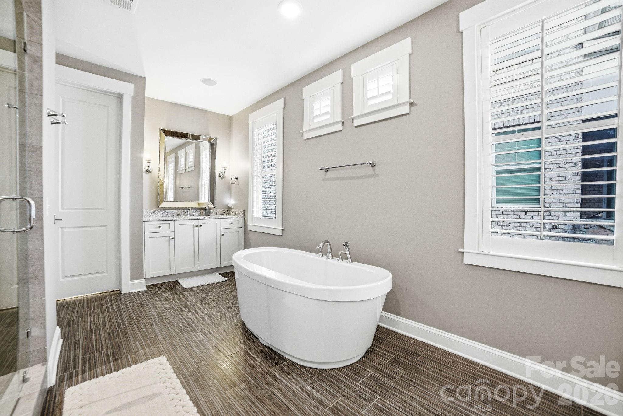17413 Robbins Ridge Road Cornelius, NC 28031 - Photo 32 of 48 a bathroom with a white toilet sitting next to a window