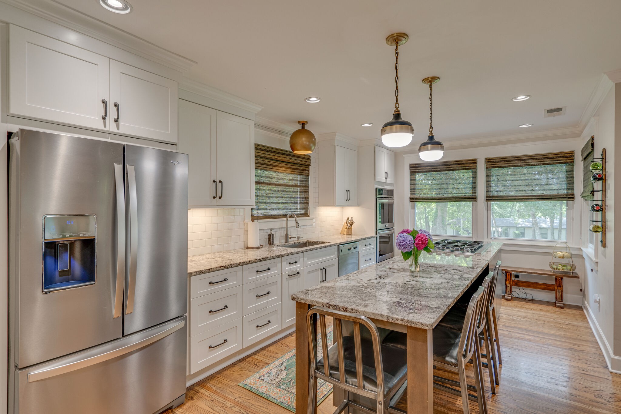 6357 Torrington Road Nashville, TN 37205 - Photo 14 of 48 a kitchen with granite countertop a refrigerator a sink dishwasher and a dining table with wooden floor