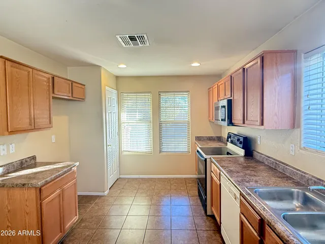 a kitchen with a sink stove and cabinets