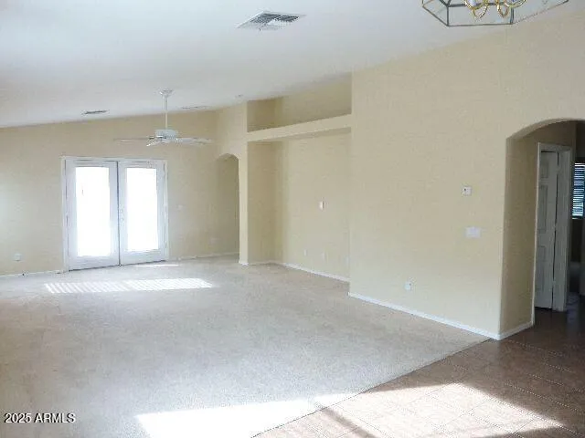 an empty room with a empty space and windows