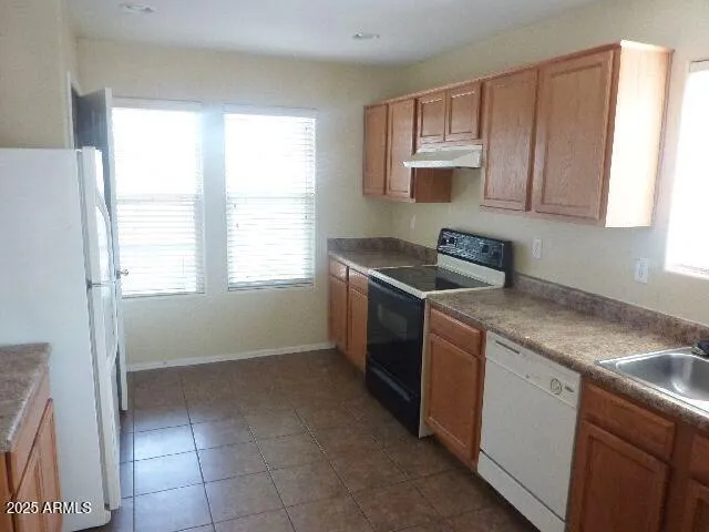 a kitchen with a stove a sink and a microwave