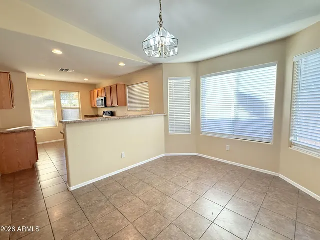 a kitchen with kitchen island a counter top space appliances and a window