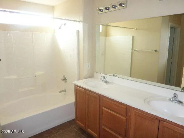 a bathroom with a bathtub sink vanity and mirror