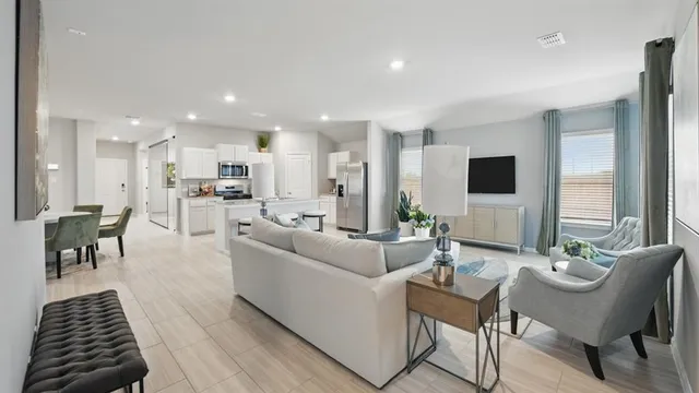 a living room with furniture and kitchen view