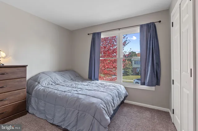 a bed sitting in a bedroom next to a window