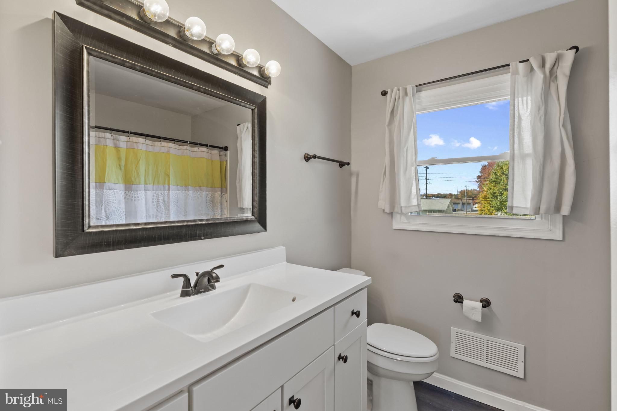 622 North West Street Dover, DE 19904 - Photo 17 of 23 a bathroom with a toilet a sink and mirror