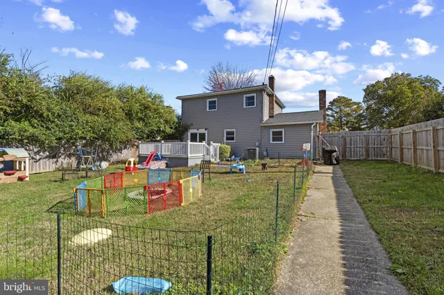 a view of yard with swimming pool and seating area