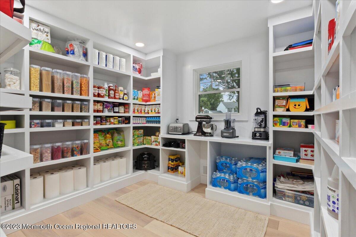 17 Quaker Road Middletown, NJ 07748 - Photo 12 of 65 a room with furniture a shelf and a book shelf