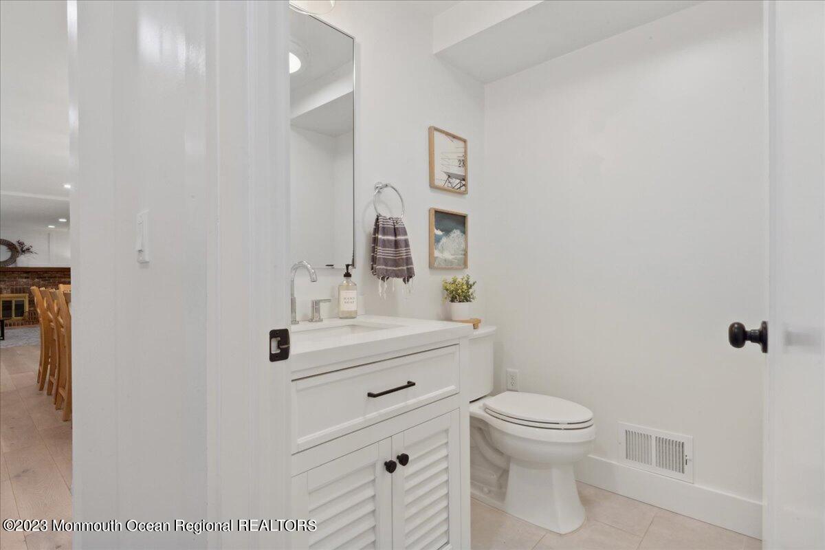 17 Quaker Road Middletown, NJ 07748 - Photo 13 of 65 a bathroom with a sink a toilet and shower