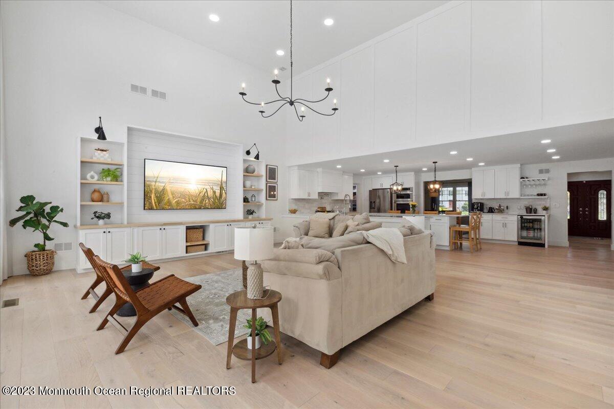 17 Quaker Road Middletown, NJ 07748 - Photo 18 of 65 a living room with furniture a table and a flat screen tv