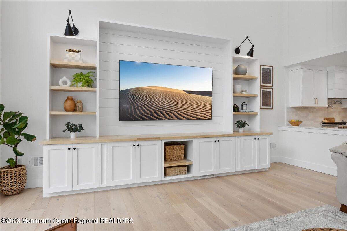 17 Quaker Road Middletown, NJ 07748 - Photo 20 of 65 a kitchen with stainless steel appliances white cabinets and a wooden floor