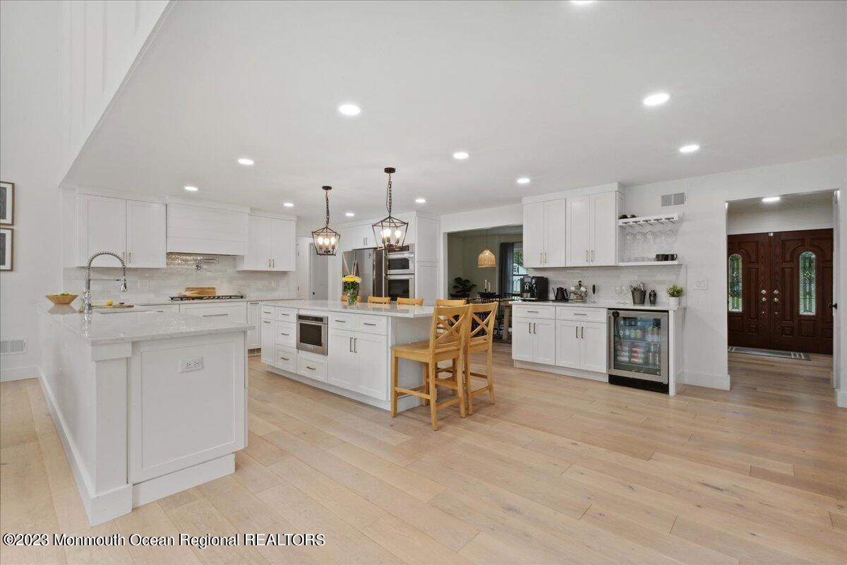 17 Quaker Road Middletown, NJ 07748 - Photo 21 of 65 a kitchen with white cabinets and stainless steel appliances