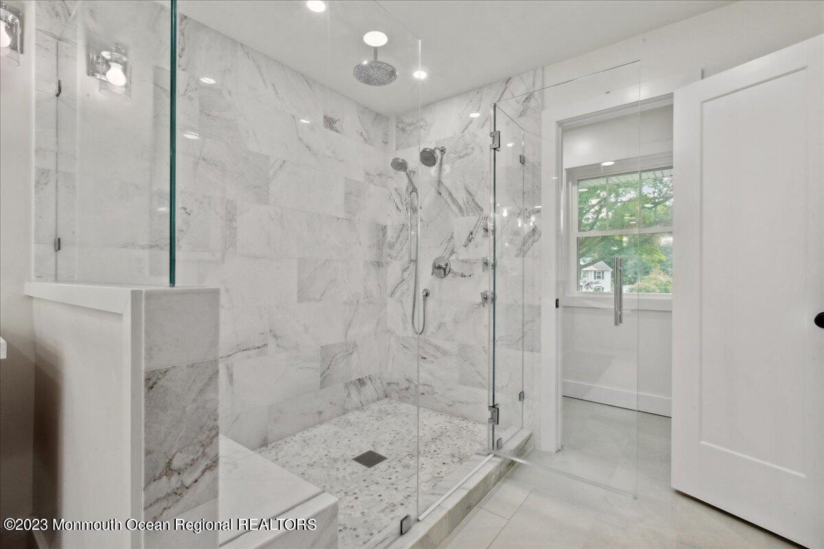 17 Quaker Road Middletown, NJ 07748 - Photo 35 of 65 a bathroom with a shower and a tub