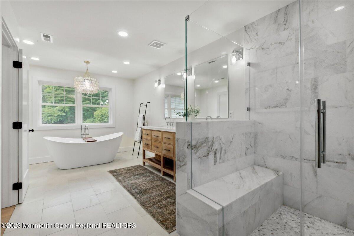 17 Quaker Road Middletown, NJ 07748 - Photo 36 of 65 a bathroom with a tub a toilet and a shower