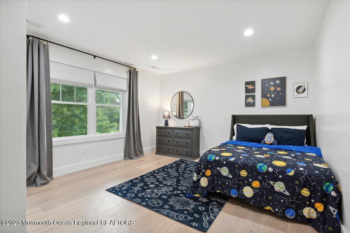 17 Quaker Road Middletown, NJ 07748 - Photo 38 of 65 a bedroom with a bed a dresser a mirror and a window