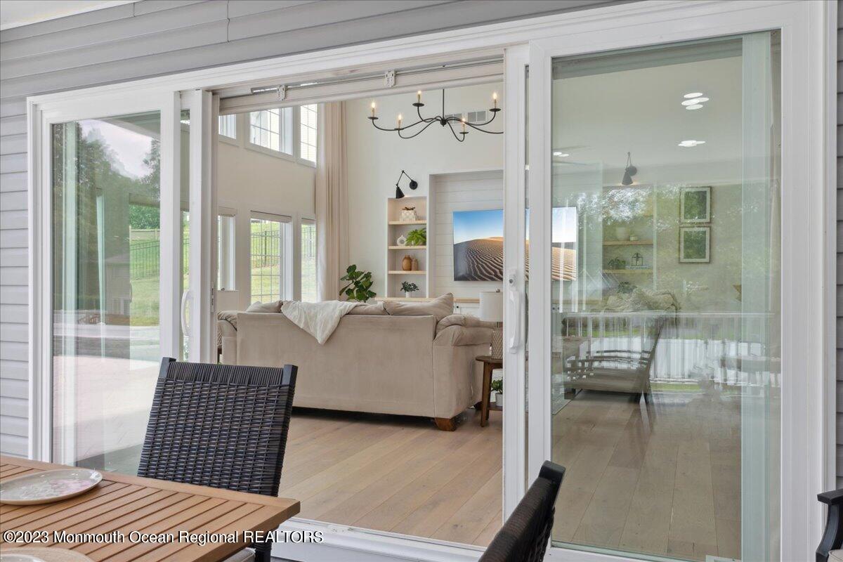 17 Quaker Road Middletown, NJ 07748 - Photo 50 of 65 a living room with furniture and a floor to ceiling window
