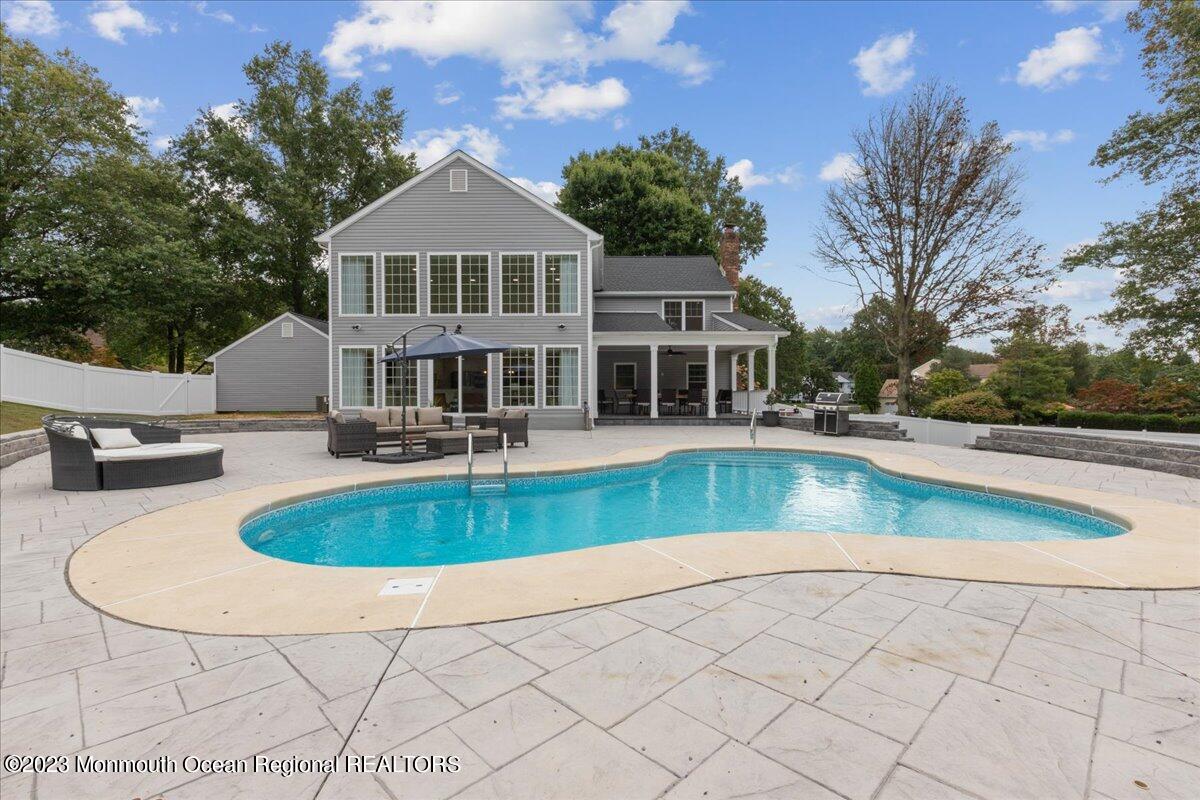 17 Quaker Road Middletown, NJ 07748 - Photo 54 of 65 a view of a house with swimming pool and sitting area