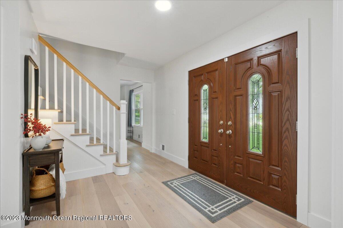 17 Quaker Road Middletown, NJ 07748 - Photo 7 of 65 a view of a hallway with wooden floor and windows